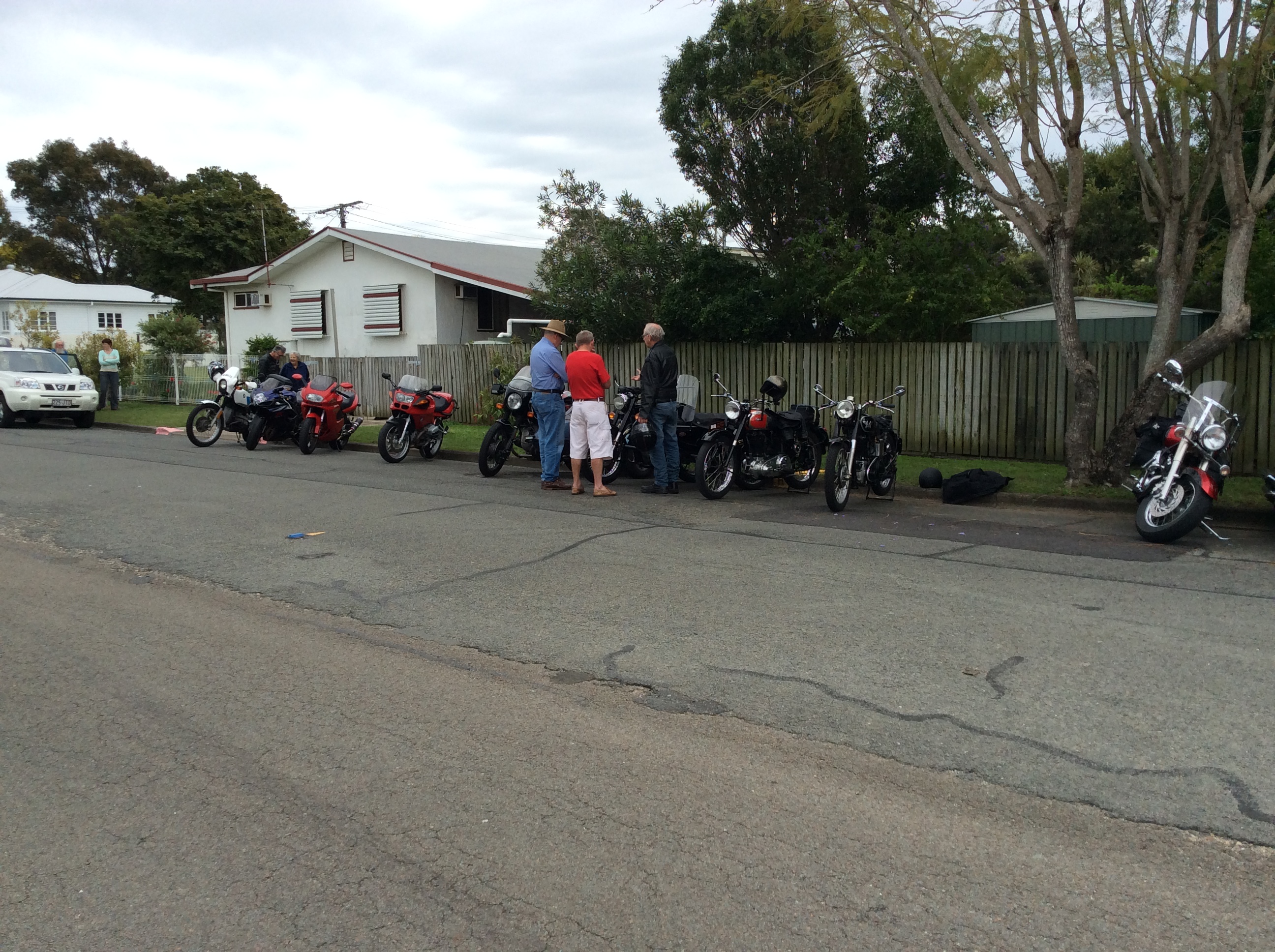 Bikes arrive and line up in front of the clubhouse.